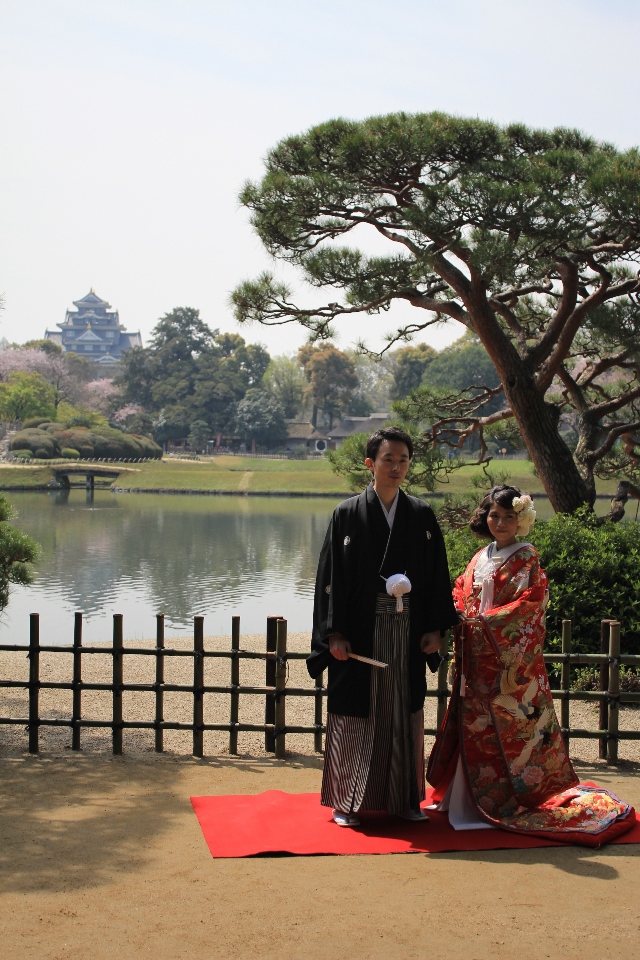 Nevěsta se ženichem v zahradě Korakuen s Okajamským hradem v pozadí